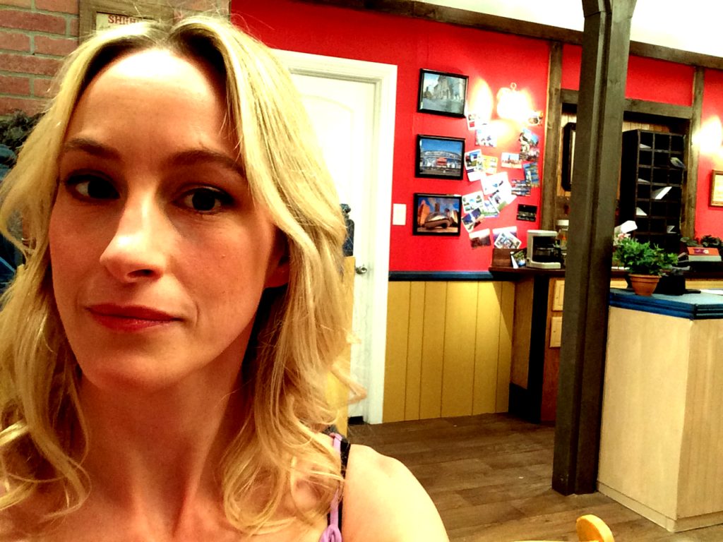 On set with the hostel's front desk in the background.