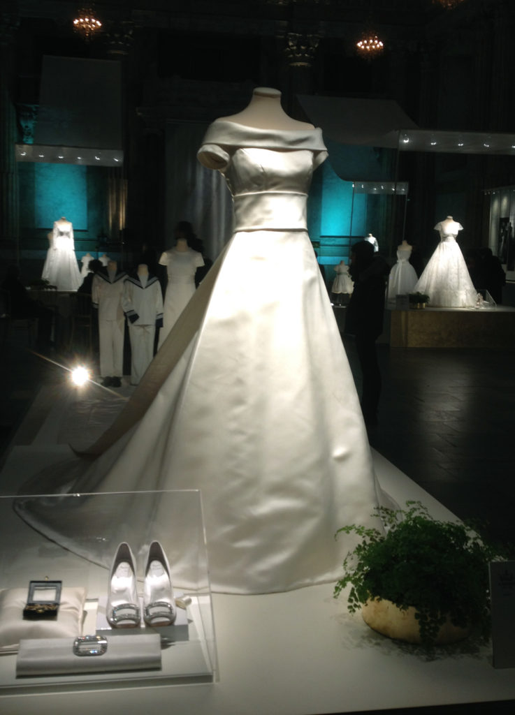 Crown Princess Victoria's wedding dress, designed by Pär Engsheden, and the shoes she wore. In the very background Princess Sofia's and Princess Madeleine's wedding dresses.