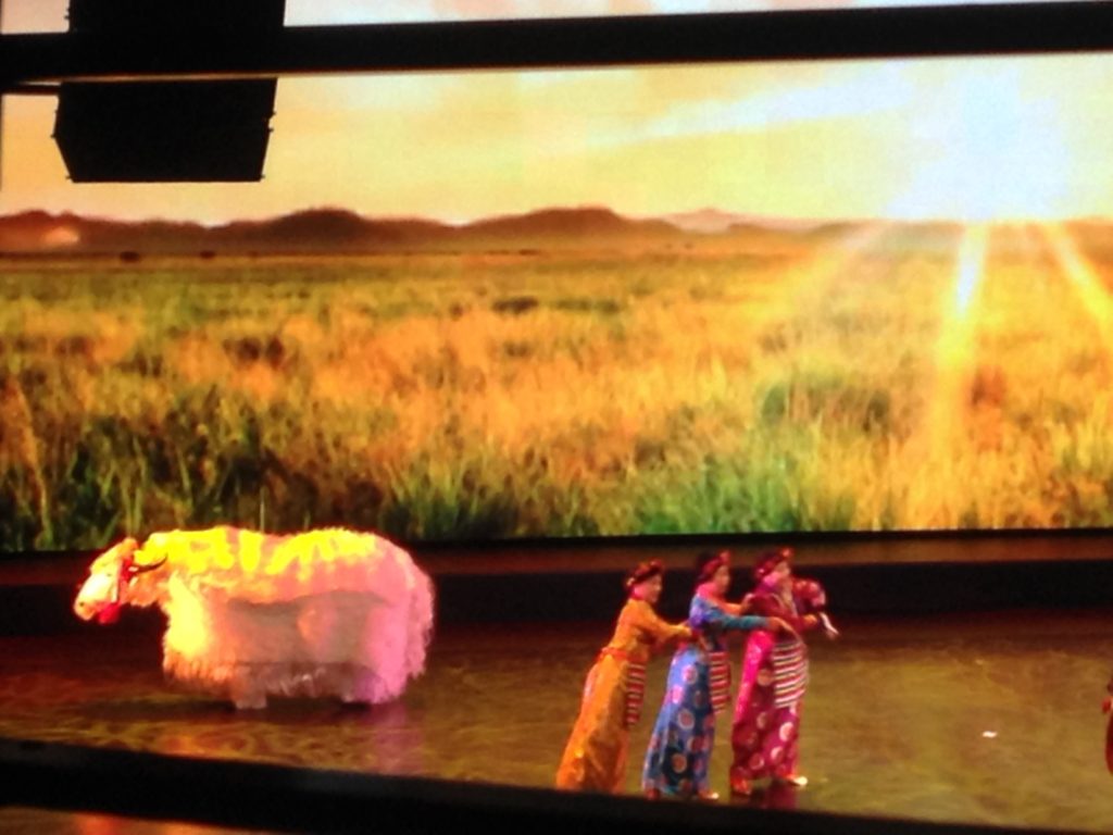 Three women working in the field. And a cow.