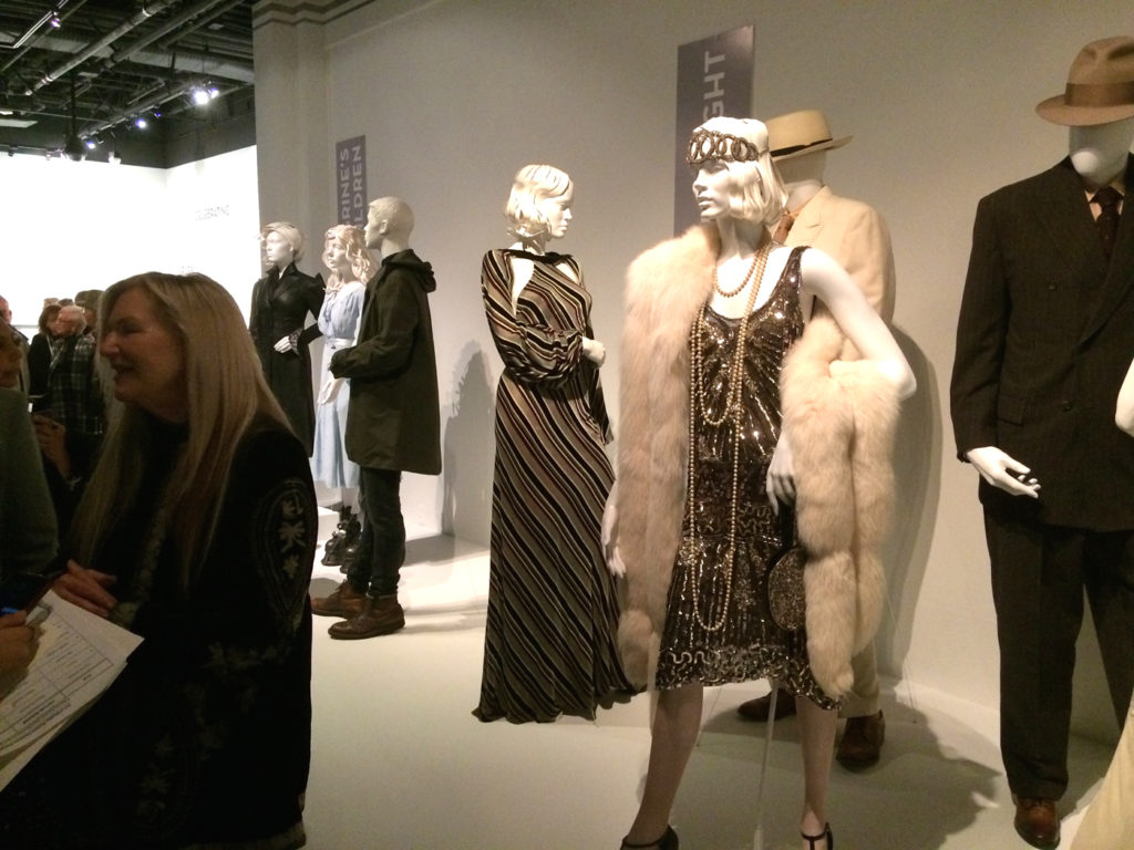 The costume designer of Live by night, Jaqueline West, is being interviewed in front of some of her work.