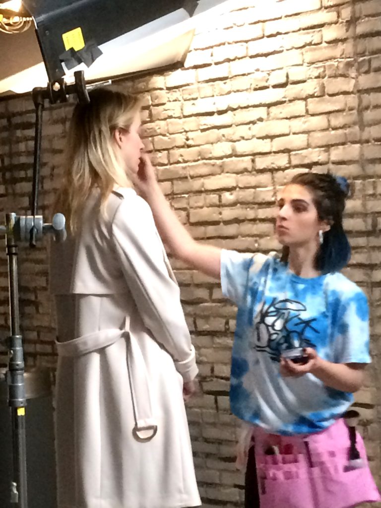 Makeup artist Savannah is retouching my makeup.