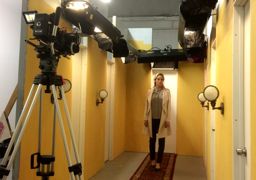 In the hallway where the movie starts and ends.