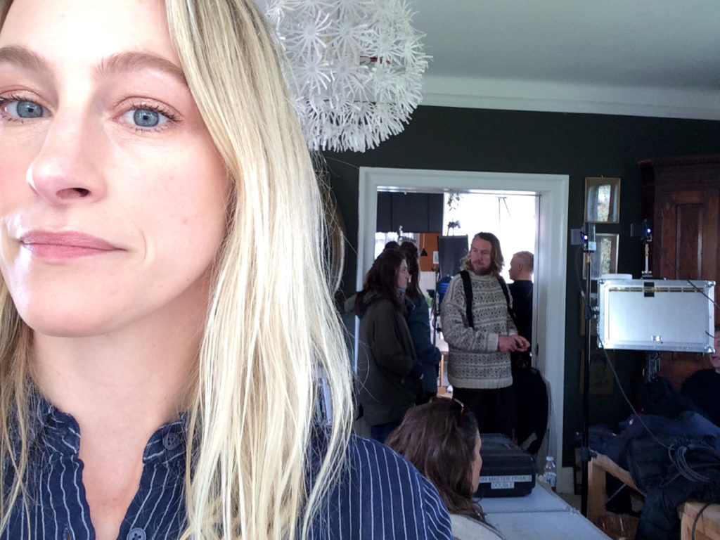 On set with the team in the background and I'm in the first outfit we tried.